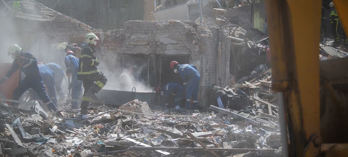 Equipes de resgate vasculham os escombros de um prédio destruído em Kyiv