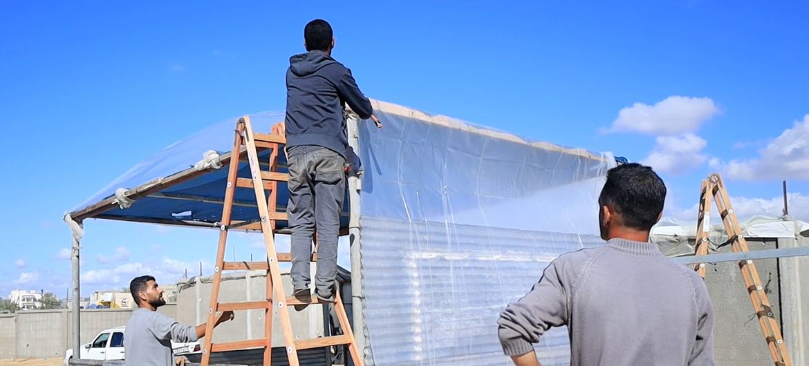 Pessoas deslocadas constroem novas tendas na área de Al-Mawasi, no centro de Gaza Pessoas deslocadas constroem novas tendas na área de Al-Mawasi, no centro de Gaza